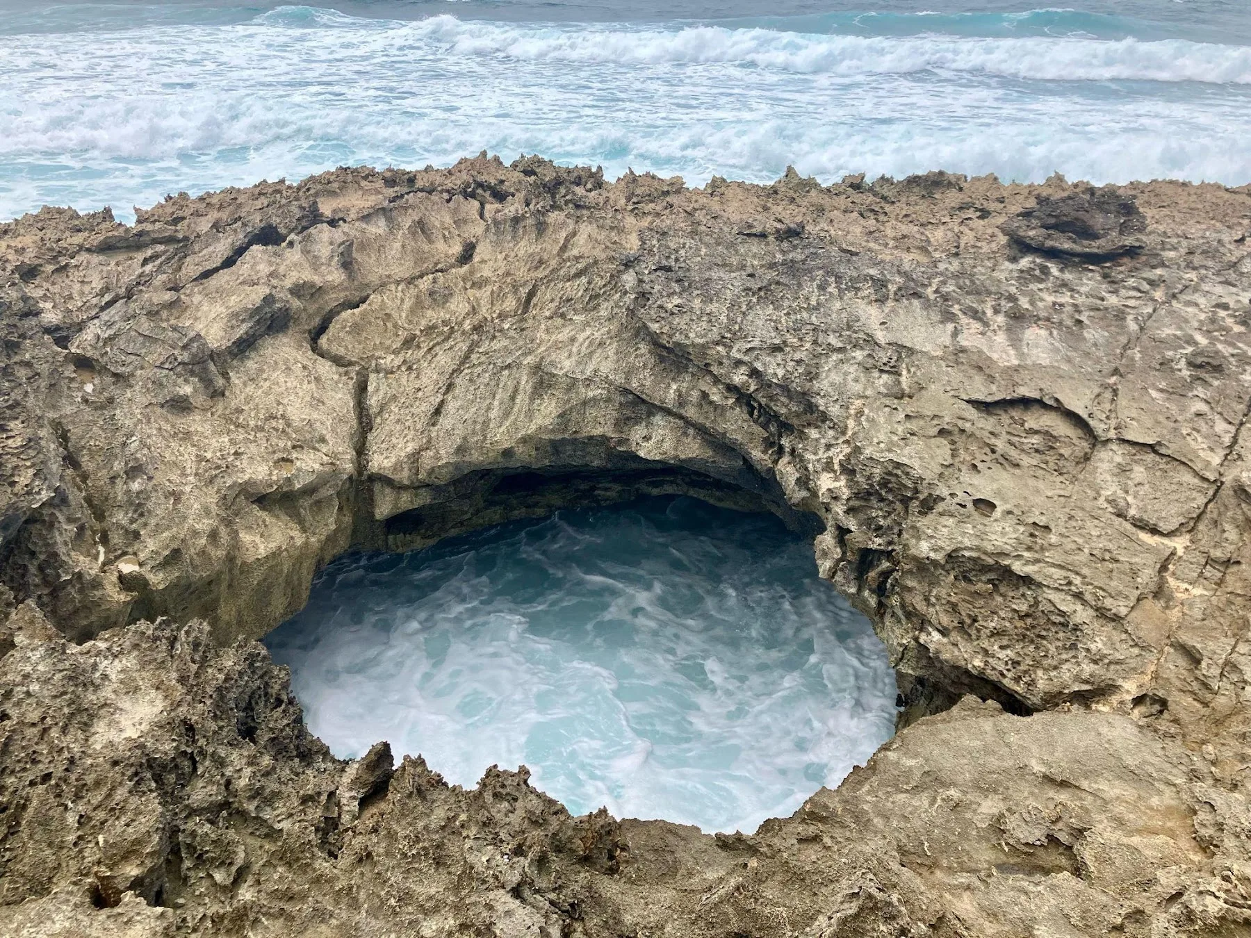 Sea water swirling inside a natural rock pool